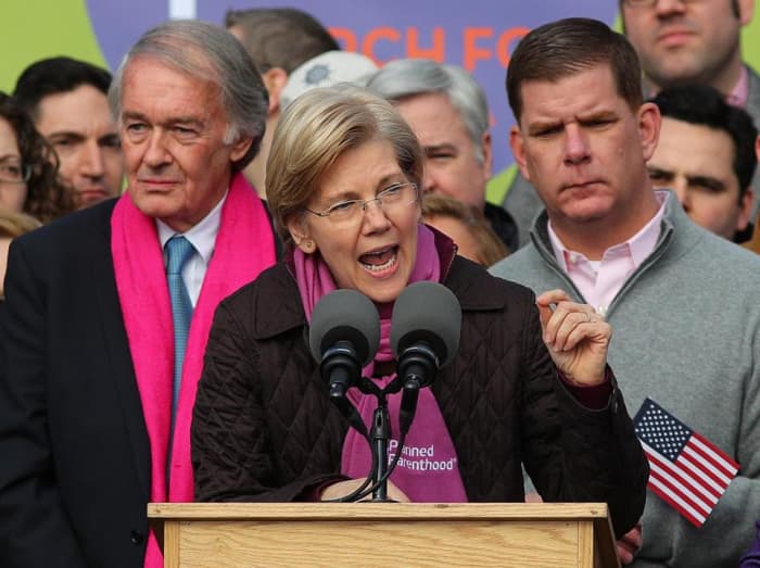 Elizabeth Warren, wearing a Planned Parenthood scarf, addresses the crowd at the Women's March on Boston