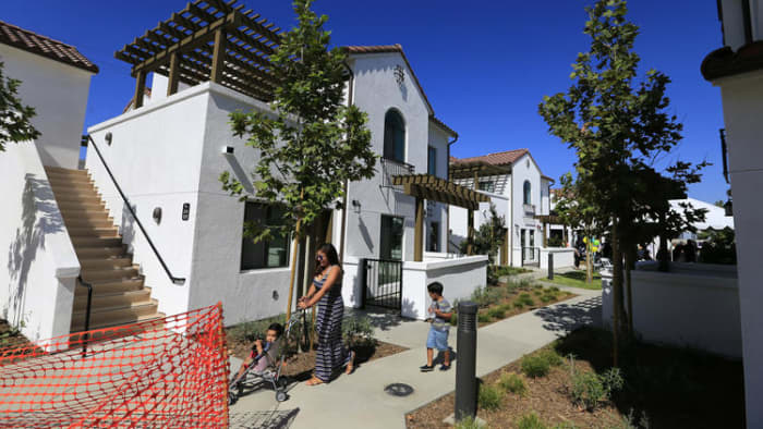 Residents take a stroll through their new complex as city and state officials gather in Vernon on July 25 to celebrate the grand opening of the Vernon Village Park Apartments, a private 45-unit affordable housing development.