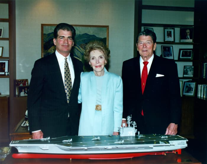 Former President Ronald Reagan and First Lady Nancy Reagan, as well as Newport News Shipbuilding Chairman and CEO Bill Fricks stand behind the model of the aircraft carrier USS Ronald Reagan (CVN-76).