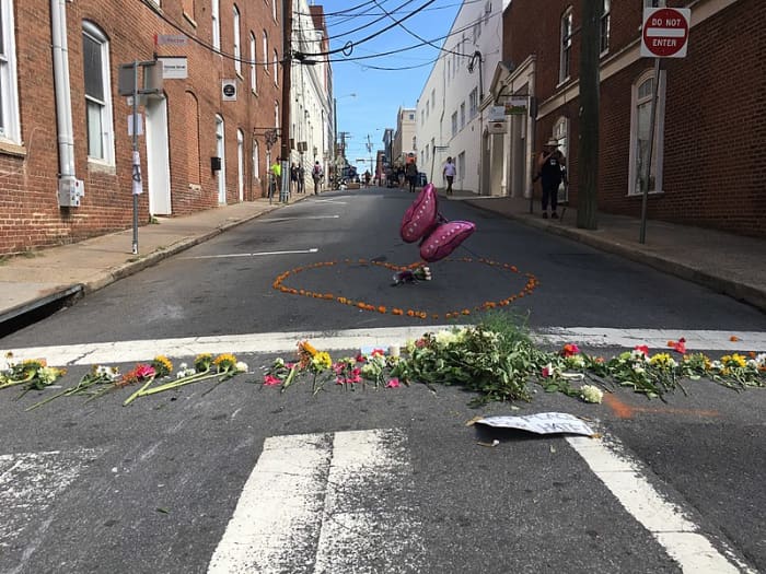 Some are willing to kill for their tribe. A floral memorial to Heather Heyer who died at the hands of a white supremacist in Charlottesville, Virginia.