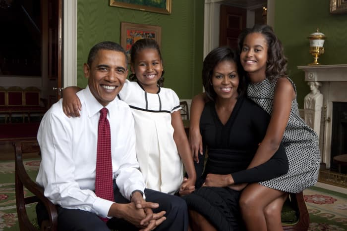 President Barack Obama, First Lady Michelle Obama, and their daughters, Sasha and Malia, sit for a family portrait in the Green Room of the White House, Sept. 1, 2009.