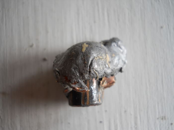 PPU 300 grain SP, .375 H&H bullet recovered from wood after 12 inches penetration. Bullet expanded to almost an inch wide and showed excellent weight retention.