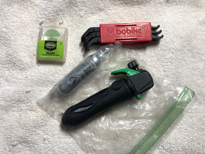 In a lot of flat tire situations, this is all you really need to get yourself going again: tire levers, patch kit, inflation source