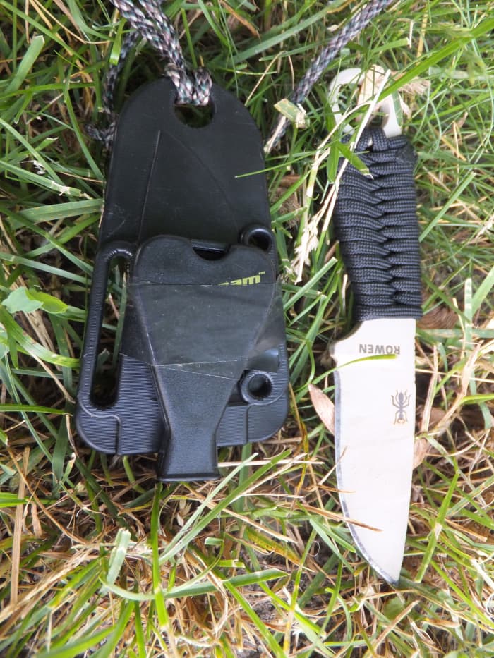 I attached a Jetscream whistle to the sheath so I could still blow it. Remember, a whistle blast carries much farther that your voice will; blow three times if you need help.