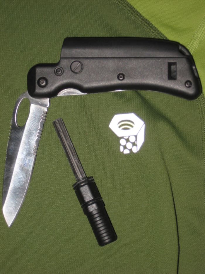 This Tool Logic knife has a partially serrated blade, a whistle in the handle and a ferrocerium sparker.