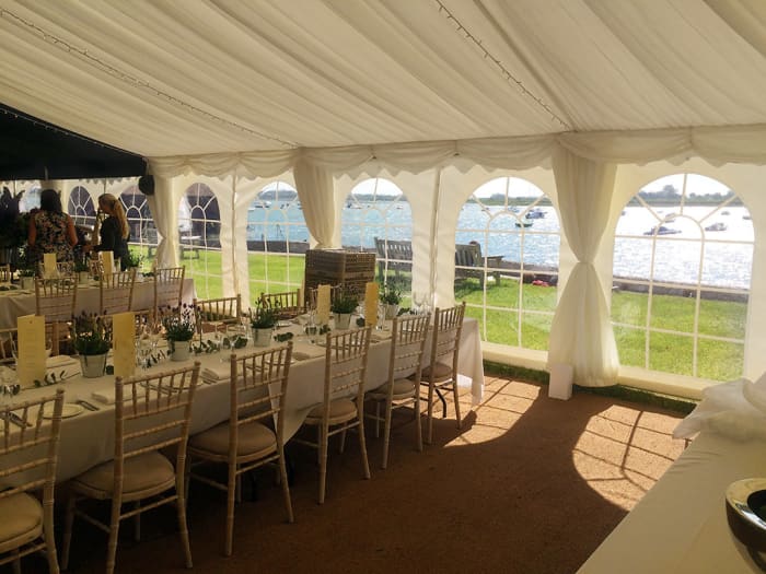 This tent features cathedral walls (walls with windows), which allow for plenty of natural light while protecting guests from wind.