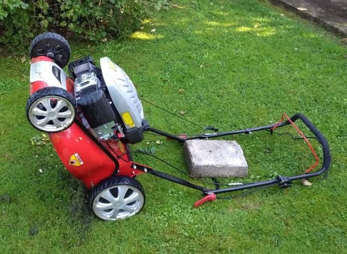 ......alternatively the mower can be placed back on its handles with a heavy weight such as a concrete block to keep it in place.