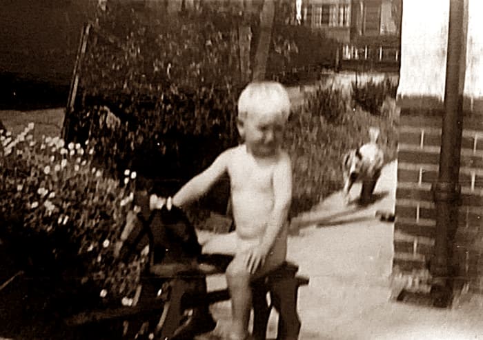 My brother as a toddler playing in the garden. Wherever he went, Peggy, his dog, was never far behind.