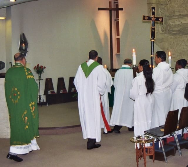 Celebrants and acolytes approach the altar to begin a special service at Saint George's in Washington, DC.