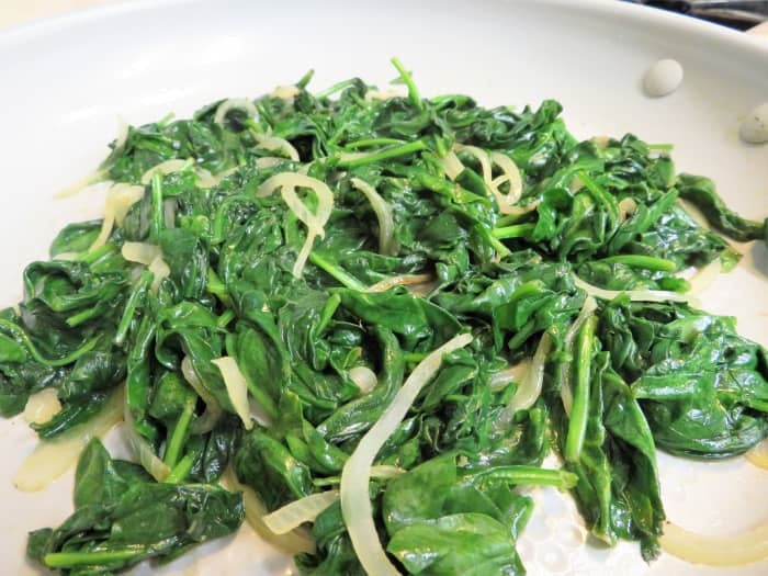 Stir until the spinach has wilted and there is no liquid left in the pan.