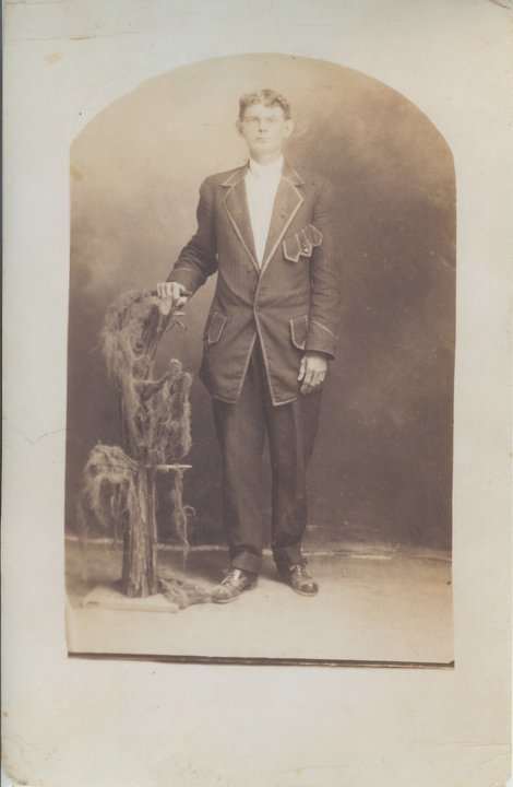 Grandfather in his dandy new suit he bought for his graduation from barber college.