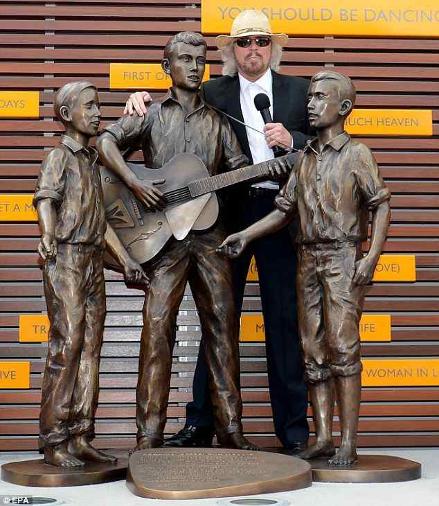 Posing alongside a bronze statue featuring the group barefoot between the ages of nine to twelve, Barry Gibb officially opened a commemorative walkway, known as Bee Gees Way, Redcliffe, Queensland