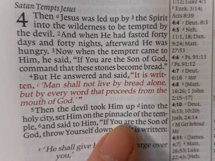 The New Testament has many Old Testament quotes in it. Many, but not all, center column references will give you the reference for the Old testament verse. Here Matthew 4:4 is quoted from Deuteronomy 8:3.