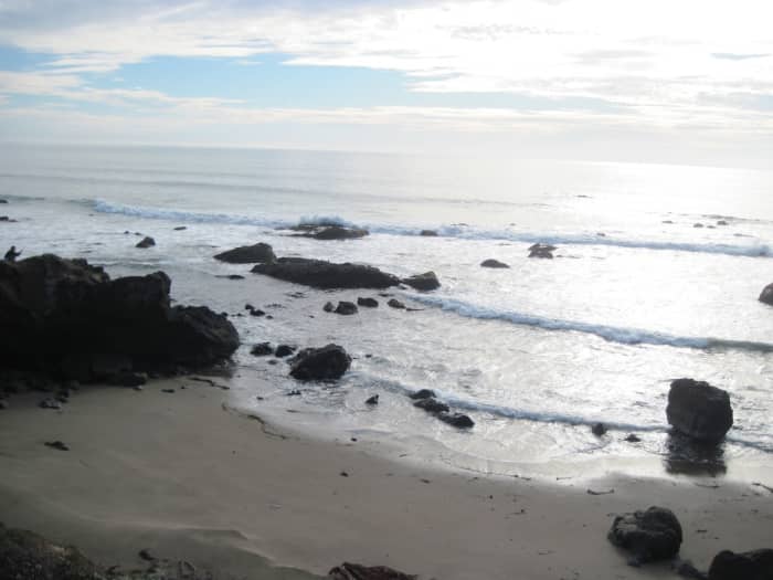 See the small man on the very left atop the rock? He watches the waves that that just keep coming, like his emotions, in waves of torment.