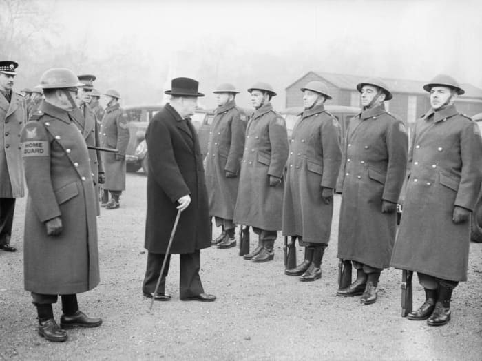 There were 50 - 60 Americans who volunteered. Winston Churchill inspects the American Squadron of the Home Guard. US Ambassador, Joe Kennedy (JFK's father and no real friend of the British), said this gave the Germans an excuse to execute Americans.