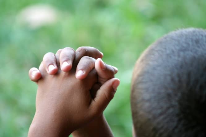 A child prays for peace and safety amidst the violence invading his community. Safe places are no longer safe, including schools, churches, playgrounds and neighborhood streets.