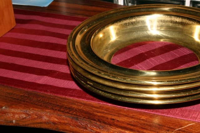 The collection plate is passed for parishioners to offer their weekly treasures to the church.