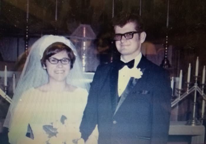 My mom had a Cathedral length train, an orchid corsage in the middle of her bouquet and a wedding cake that was shaped like a Cathedral. She got married Labor Day weekend, so she had her attendants in forest green, purple, fuchsia, and copper.