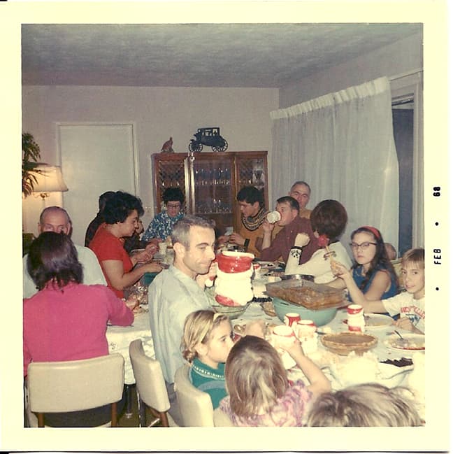Christmas Dinner in the '60s. I'm the dark haired girl with the cat-eye glasses on the right.