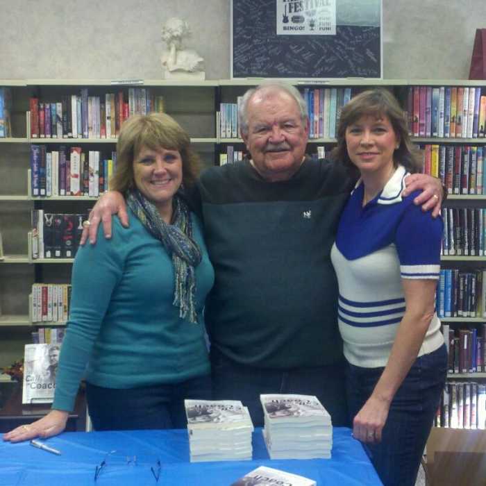 My dad and I at a book signing in 2012. My friend Annette showed up in her cheerleading sweater to surprise my dad.