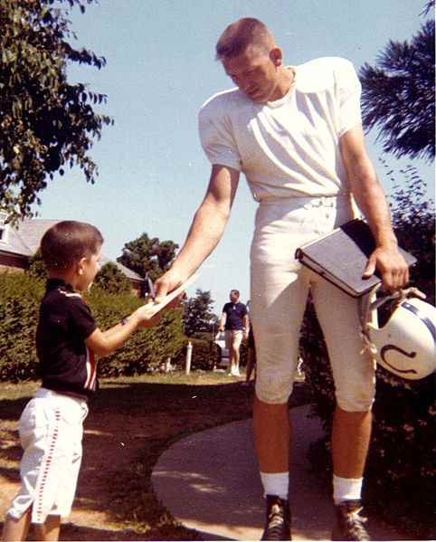 Johnny Unitas Baltimore Colts quarterback signs autograph at West Minster training camp.