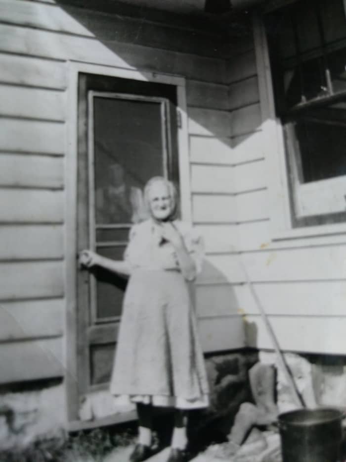 My little grandma outside of her home in probably the early 50s. The man behind the screen door is probably great-uncle John.
