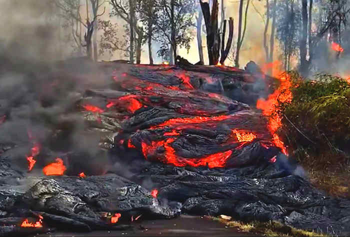 A wall of lava comes down a residential street. (Photo courtesy of USGS-HVO)