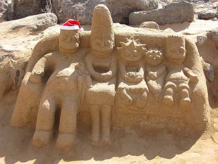 The Simpson family on their couch: Homer, Marge, Lisa, baby Maggie, and Bart.