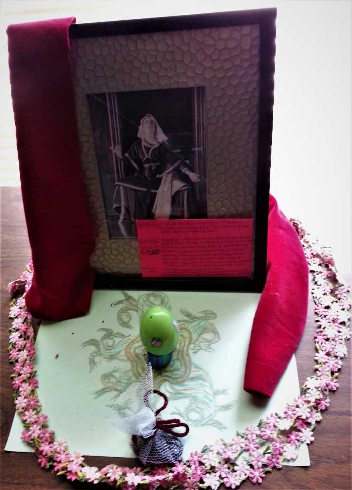 Framed photo of me playing the Virgin Mary from a Performance of Bach's Christmas Oratorio set up as an altar in my office