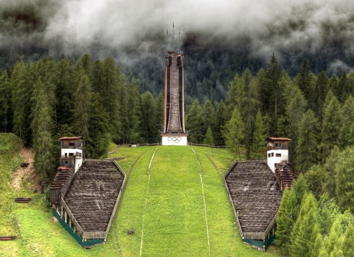 The silent ski jump, Trampolino Olimpico, still carries the Olympic rings but hasn't carried an event since 1990.