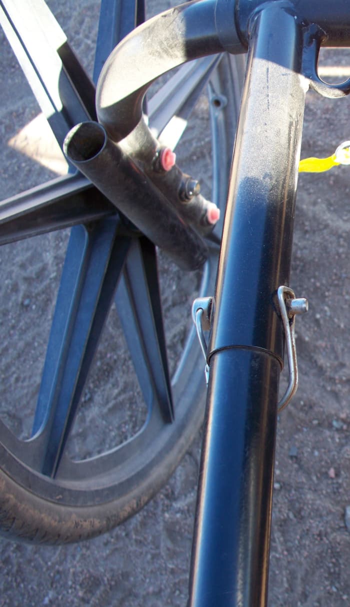 The two red dots are plugs for the axle callouts. Really handy for your miniature as they allow the frame to be raised or lowered according to the height of the mini.