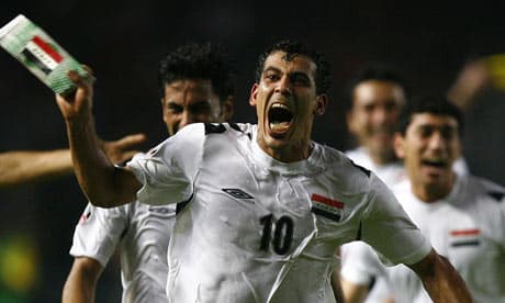 Younis Mahmoud (10) celebrates with teammates behind him after scoring against Saudi Arabia to give Iraq its first Asian Cup.