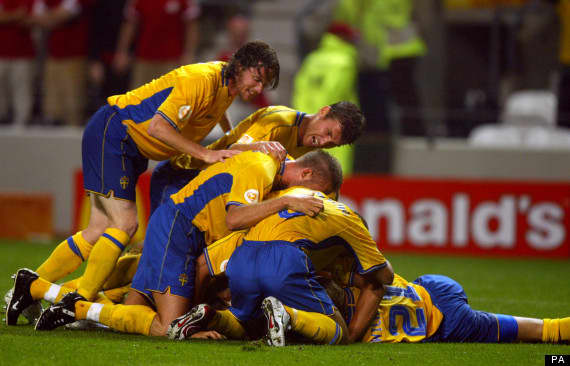 Swedish players come over to congratulate Mattias Jonson after scoring the tying goal in a Euro 2004 match against Denmark. Jonson's goal made the match 2-2 and the result was what got Sweden and Denmark through to the quarterfinals.
