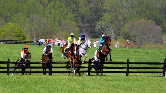 A steeplechase is a cross-country horserace in which participants must jump numerous wooden rail hurdles called "timbers."