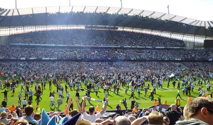 Manchester City fans invading the pitch after their last gasp title victory in 2012. It was their first title in the Premier League era and their first top division title since 1968.
