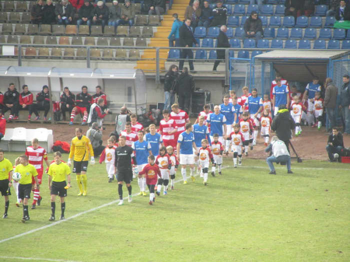 Players walk onto the field at Stadion am Böllenfalltor on Mar. 3, 2013 between SV Darmstadt 98 and Hallescher FC. SV Darmstadt 98 lost this match 2-1 as the club finished 14th in the 2012-13 3. Liga.