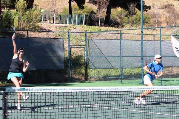 The author (pictured right) closing the net behind her partner's overhead at the 2011 NorCal Sectional Championships. As a result of playing this event, Micki received a B designation after her 5.0 rating.