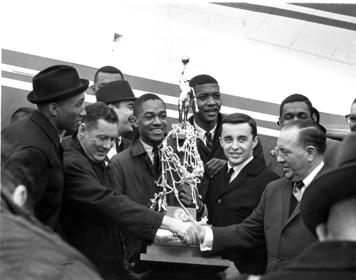 Loyola players arrive at O'Hare on March 24, 1963. Front row, L-R: Vic Rouse, Coach George Ireland, Jerry Harkness, Les Hunter, John Egan, Mayor Richard J. Daley.
