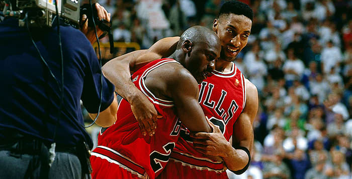 An exhausted Michael Jordan leans on Scottie Pippen after a 38-point outburst despite having flu-like symptoms.
