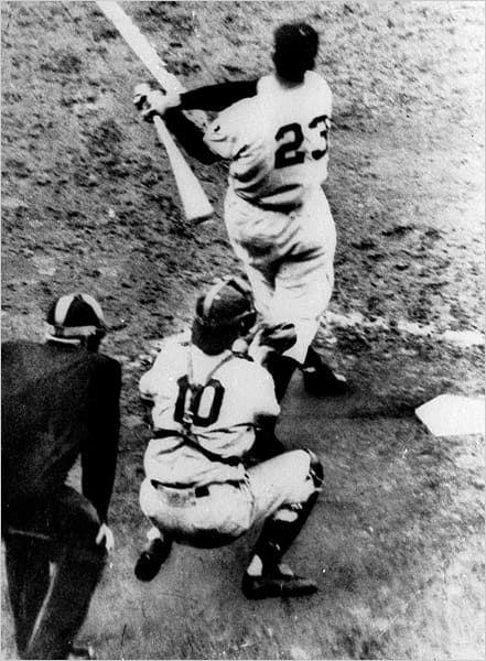 Bobby Thomson swings into history. The Dodger catcher is Rube Walker, playing for the injured Roy Campanella.