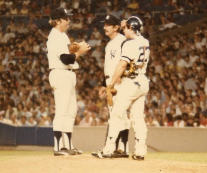 Billy Martin on the mound with Catfish Hunter, probably asking if he can gut it out to finish the game. Hunter had 30 complete games for Martin in 1975.