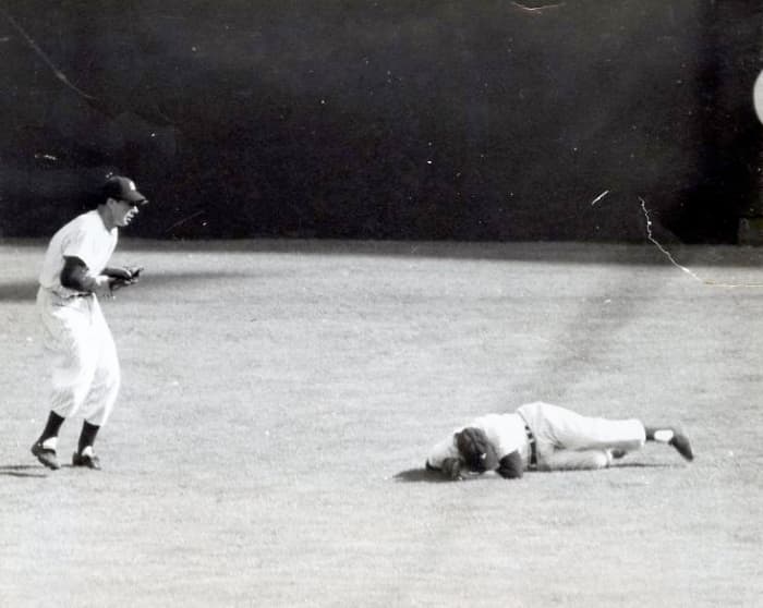 Game 2, 1951 World Series: Dimaggio catches Mays' fly ball as Mantle sustains the first of many knee injuries.