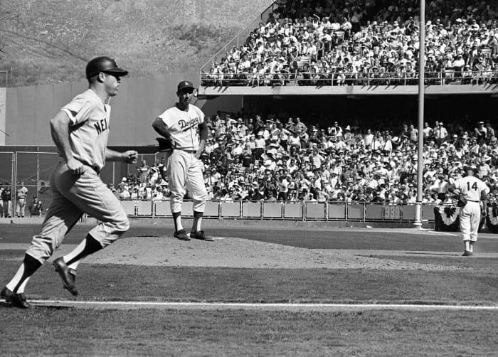 A disgusted Koufax watches Mantle round the bases after hitting his only homer of the Series.