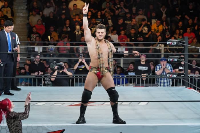MJF at an MLW appearance, wearing the most heelish of fashion accessories - a scarf.