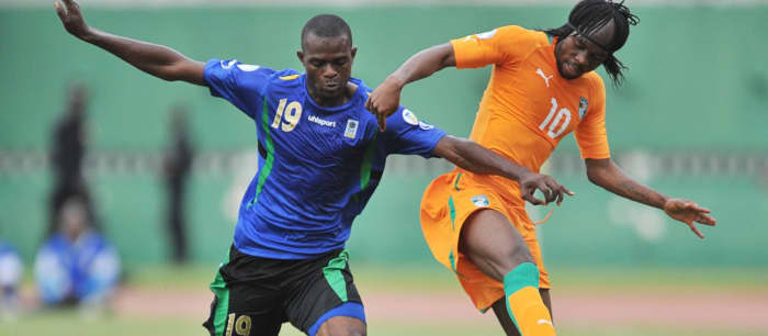 Shaban Nditi (#19) of Tanzania battles for possession with Côte d'Ivoire's Gervinho (#10) during a 2014 FIFA World Cup qualification match in Abidjan's Stade Félix Houphouët-Boigny. on June 1, 2012.
