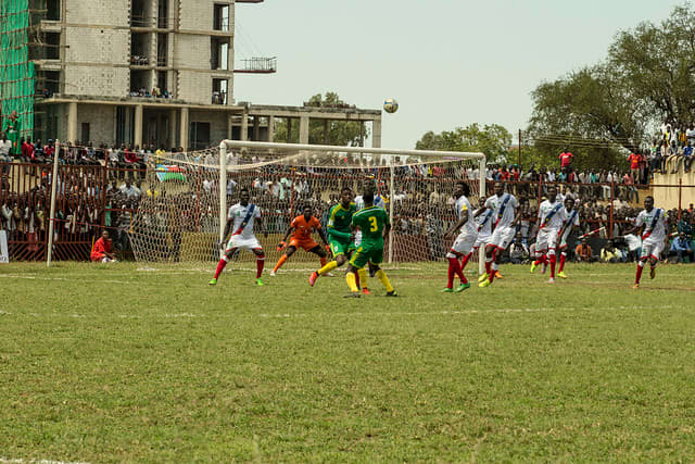 Taghiyoullah Denna (green #17) and Aly Abeid (green #3) are in action for Mauritania during a 2018 FIFA World Cup qualifier in Juba, South Sudan. This qualifier spanned two days during October 2015 due to torrential rain.