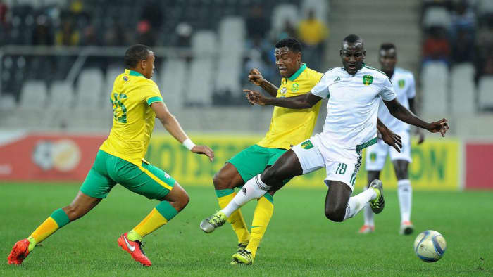 A Mauritanian player battles for possession with two South African players during a 2017 Africa Cup of Nations qualifying match in Nelspruit, South Africa. With the 1-1 draw in this match, Mauritania finished second in its qualifying group.