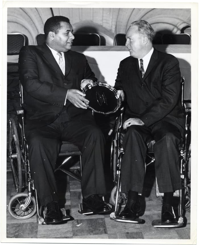 Former Dodgers Hall of Famer Roy Campanella (left) shares a moment with former Boston Mayor John F. Collins. Campanella was forced into a wheelchair after an automobile accident prematurely ended his baseball career.