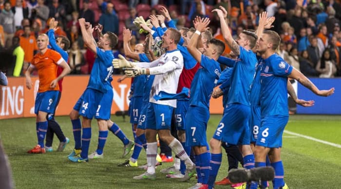 Iceland players celebrate with fans following a Euro 2016 qualifier at the Amsterdam Arena. The 1-0 victory against the Netherlands marked a significant milestone that helped Iceland secure qualification for Euro 2016.