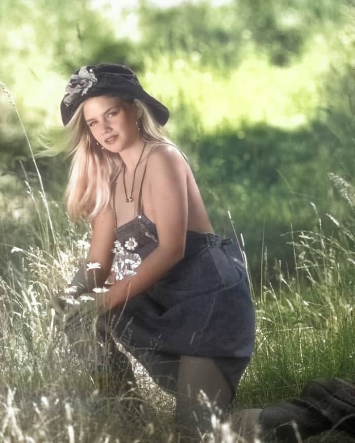 A photo with only auto colorize applied, resulting in somewhat muddy-looking color and partially gray hands, wrists and legs.